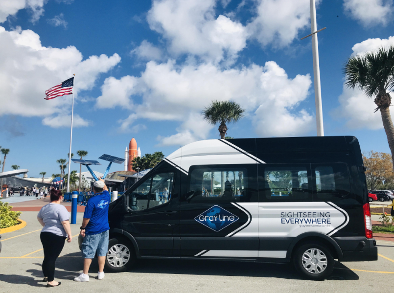 Gray Line Orlando Tour Van infront of Kennedy Space Center with people Gray Line Orlando Tour Van infront of Kennedy Space Center with people