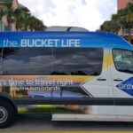 Gray Line Orlando Tour van infront of buildings