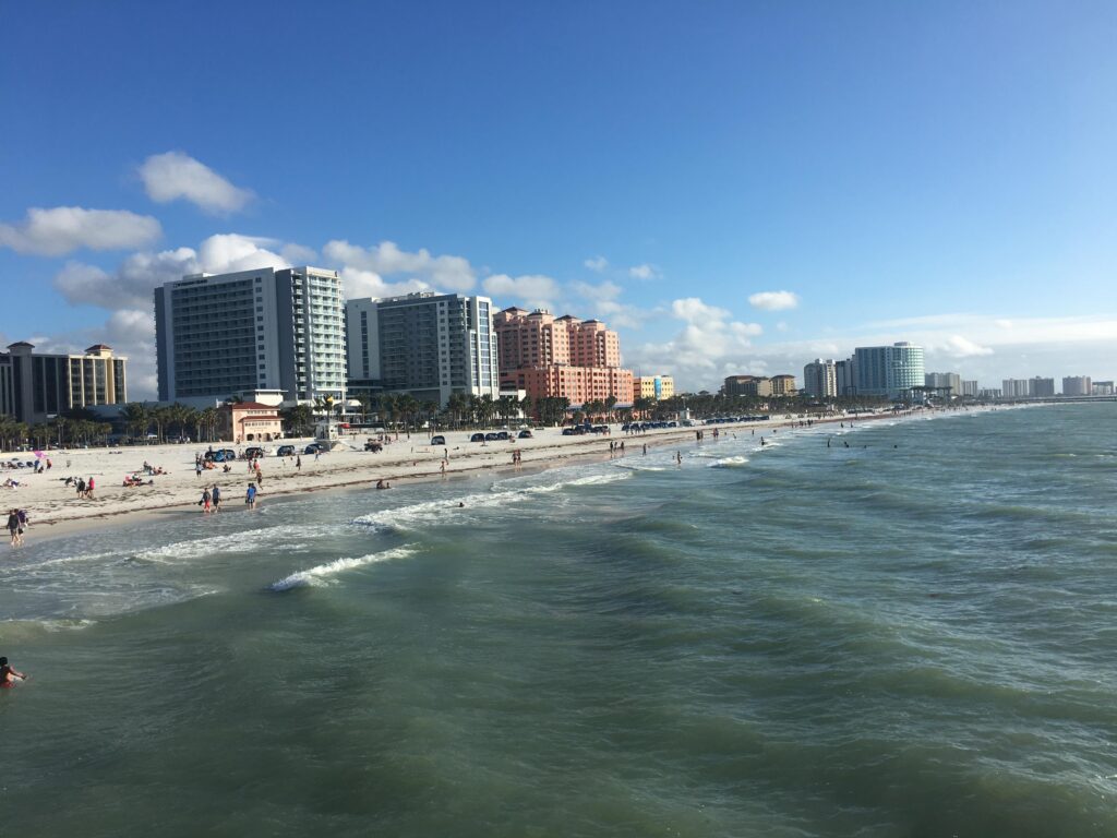 A picture taken from Pier 60 looking south down the beach at cleawater seeing the water and the sand